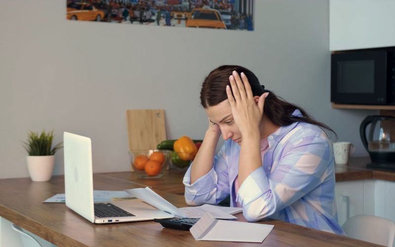 a-woman-has-problems-after-reading-a-tax-debt-bill-confiscation-of-property-SBI-350074979