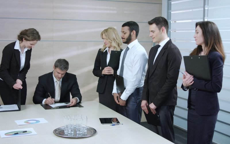 businessman-signs-a-contracts-top-manager-accepts-projects-employees-performing-the-wo-SBI-350055511